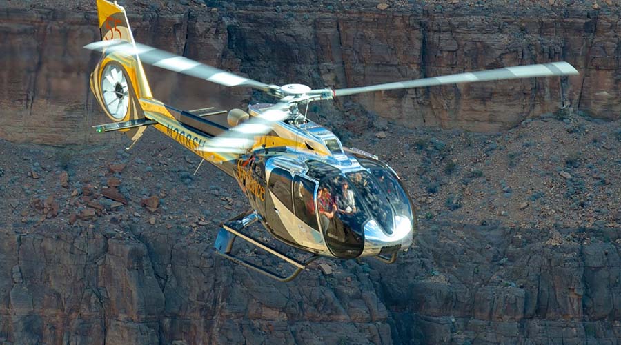 Sundance Helicopter Soaring Past Grand Canyon Cliffs