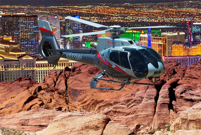 Helicopter over Vegas neon and Red Rock Canyon